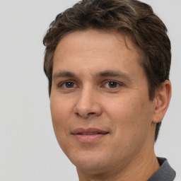 Joyful white adult male with short  brown hair and brown eyes