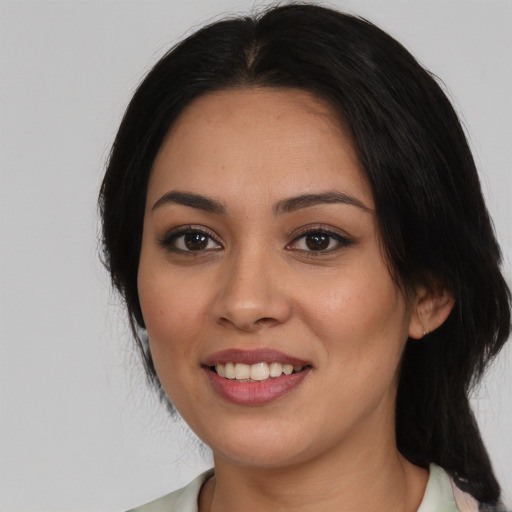 Joyful white young-adult female with medium  black hair and brown eyes