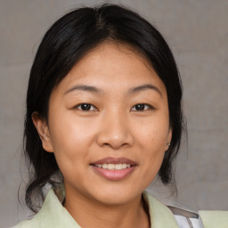 Joyful asian young-adult female with medium  brown hair and brown eyes