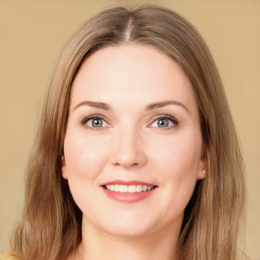 Joyful white young-adult female with long  brown hair and green eyes