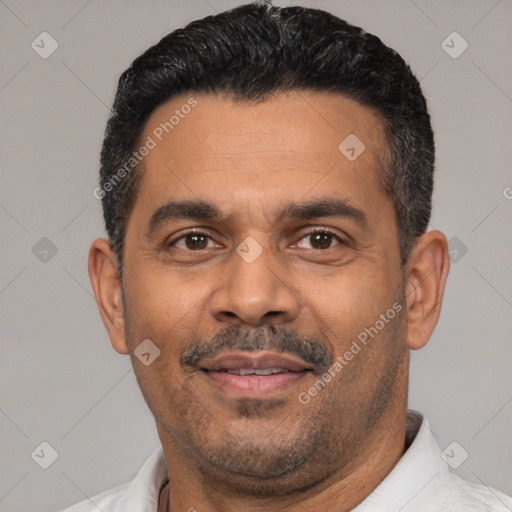 Joyful latino adult male with short  black hair and brown eyes