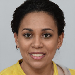 Joyful latino young-adult female with short  brown hair and brown eyes
