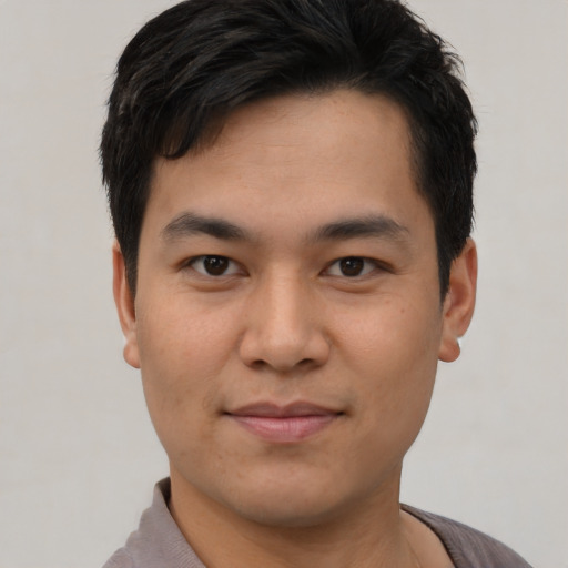 Joyful asian young-adult male with short  black hair and brown eyes