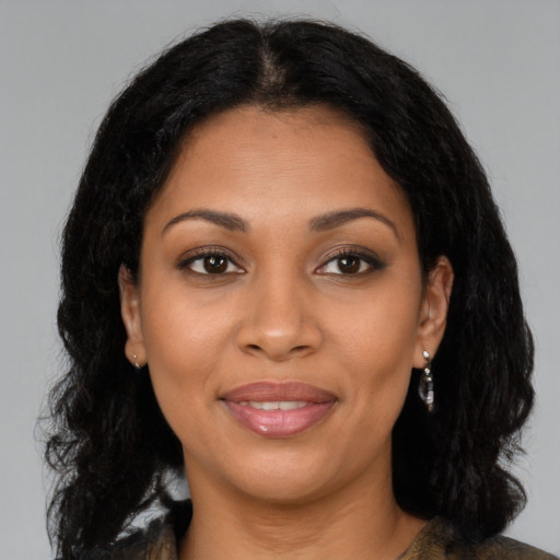 Joyful latino young-adult female with medium  brown hair and brown eyes