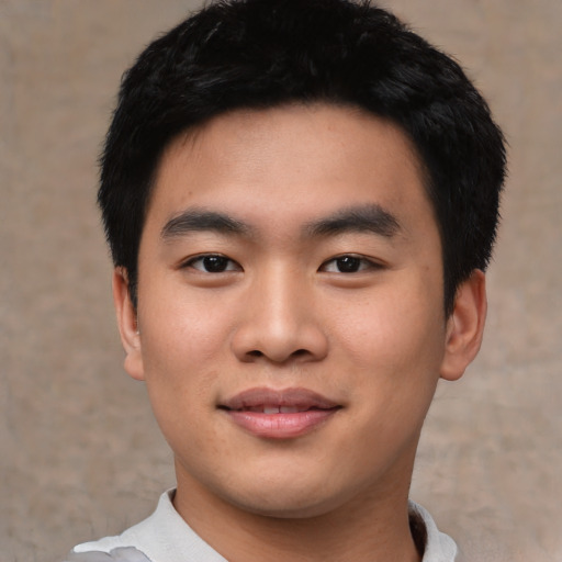 Joyful asian young-adult male with short  black hair and brown eyes