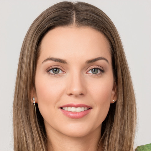 Joyful white young-adult female with long  brown hair and green eyes