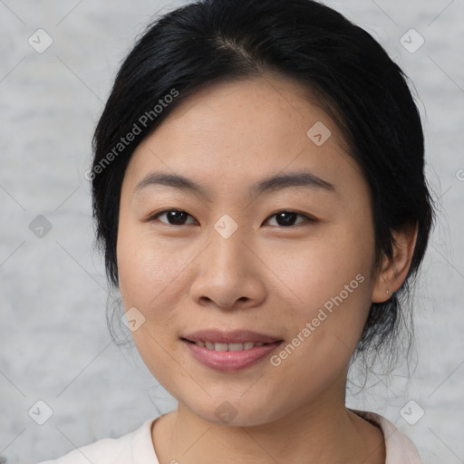 Joyful asian young-adult female with medium  black hair and brown eyes