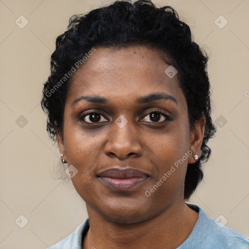 Joyful black young-adult female with short  black hair and brown eyes