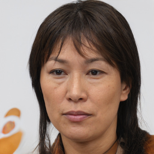 Joyful asian adult female with medium  brown hair and brown eyes