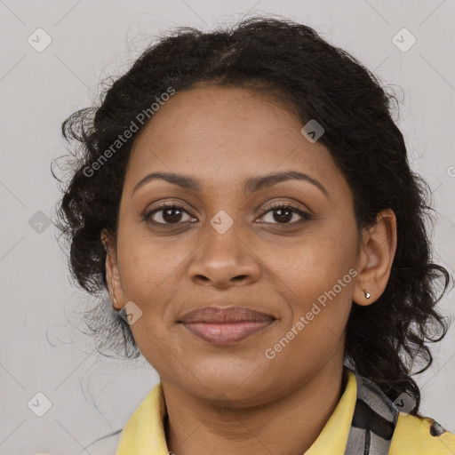 Joyful black adult female with long  brown hair and brown eyes