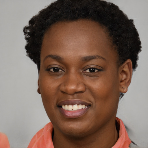 Joyful black young-adult female with short  brown hair and brown eyes