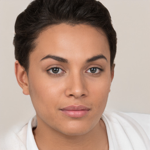 Joyful white young-adult female with short  brown hair and brown eyes