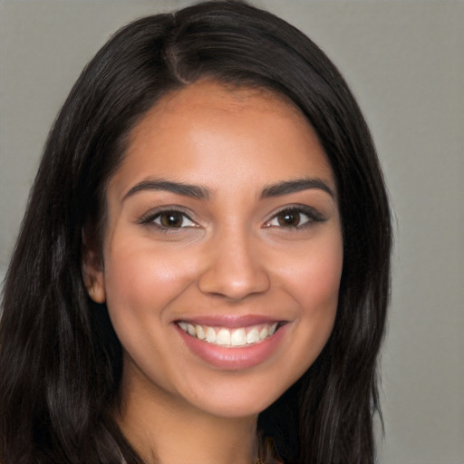 Joyful white young-adult female with long  black hair and brown eyes