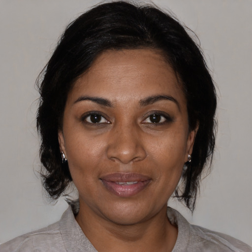 Joyful black adult female with medium  black hair and brown eyes