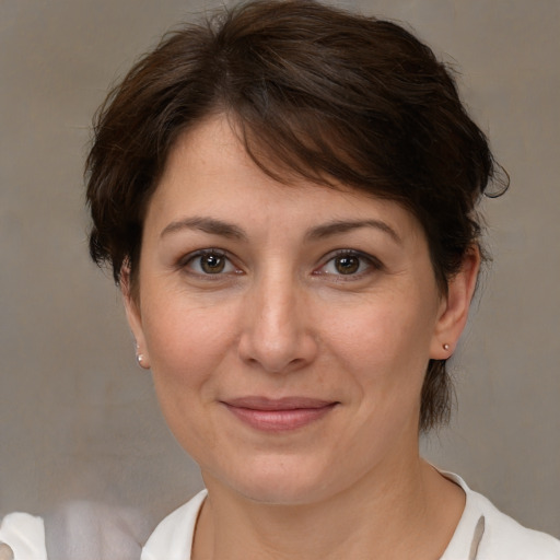 Joyful white adult female with medium  brown hair and brown eyes