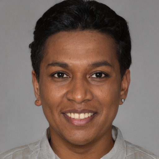 Joyful latino adult female with short  black hair and brown eyes