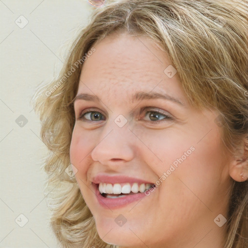 Joyful white young-adult female with long  brown hair and green eyes