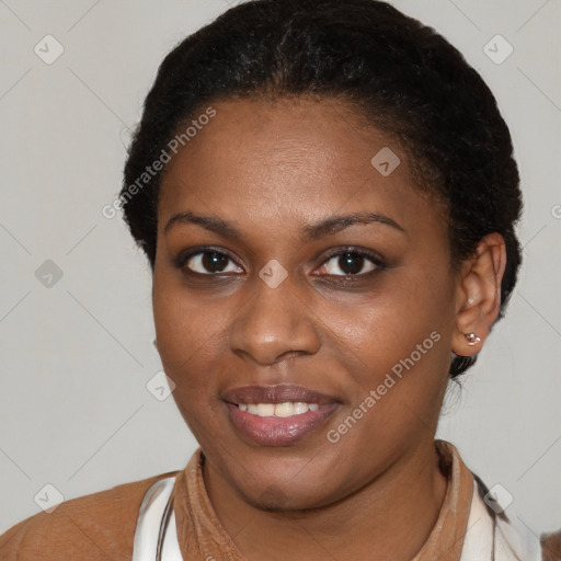 Joyful black young-adult female with short  brown hair and brown eyes