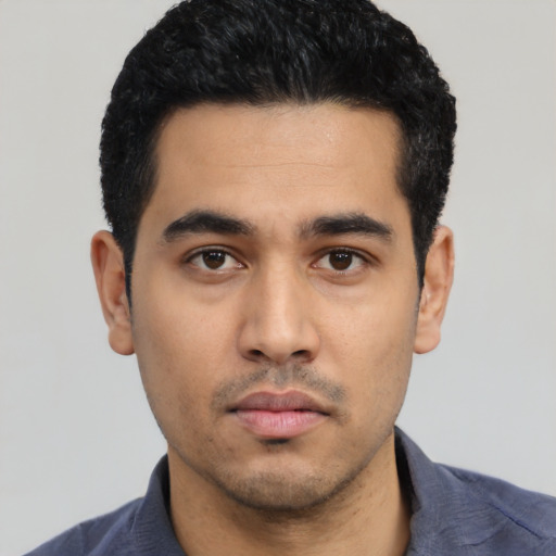 Neutral latino young-adult male with short  black hair and brown eyes