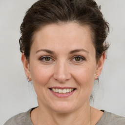 Joyful white adult female with medium  brown hair and brown eyes