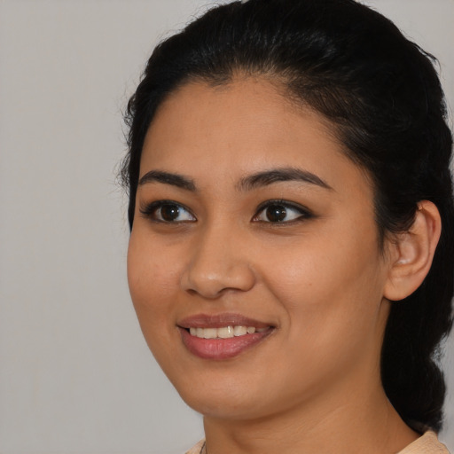 Joyful latino young-adult female with medium  black hair and brown eyes