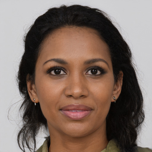 Joyful black young-adult female with medium  brown hair and brown eyes