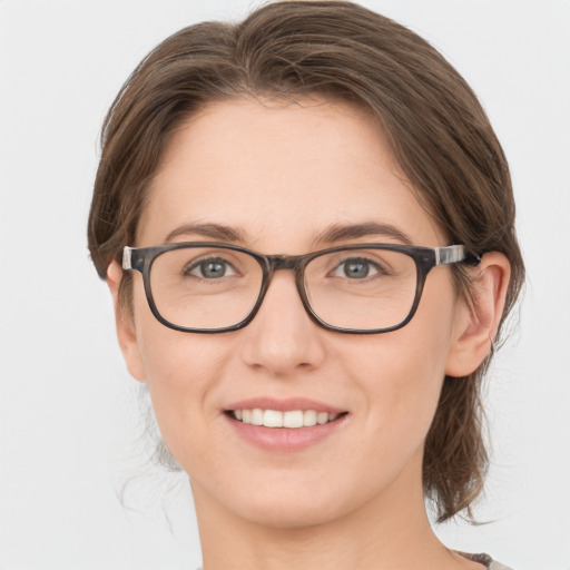 Joyful white young-adult female with medium  brown hair and grey eyes