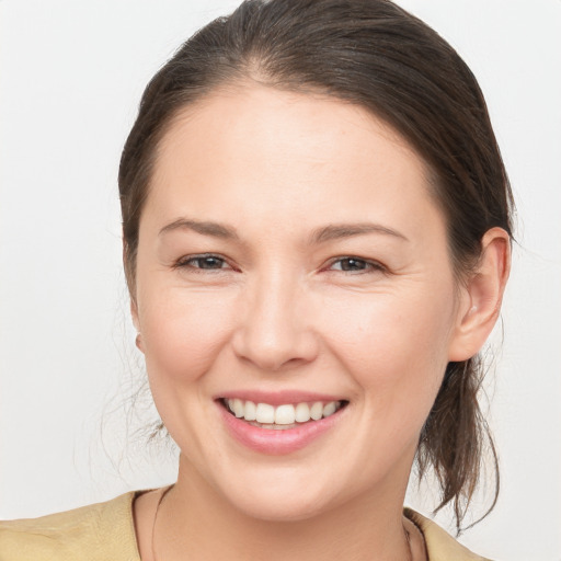 Joyful white young-adult female with medium  brown hair and brown eyes