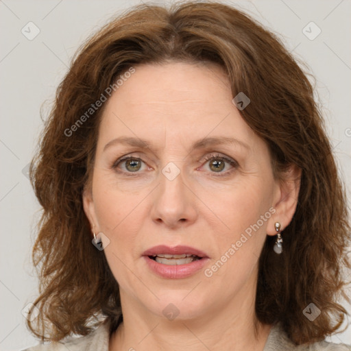 Joyful white adult female with medium  brown hair and green eyes