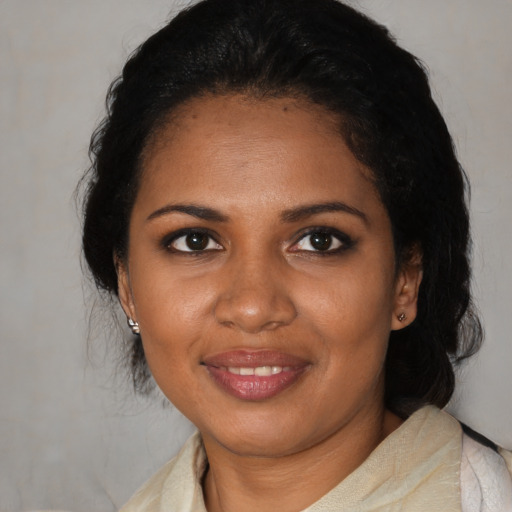 Joyful black young-adult female with medium  black hair and brown eyes