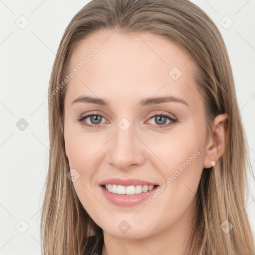 Joyful white young-adult female with long  brown hair and grey eyes