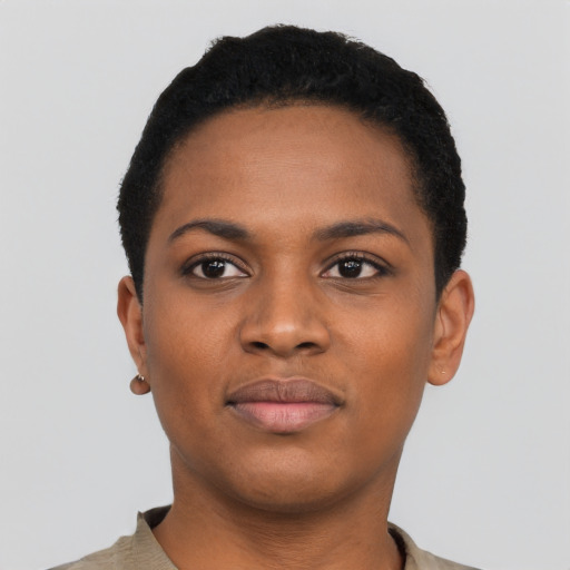 Joyful black young-adult female with short  black hair and brown eyes