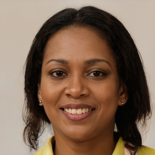 Joyful black young-adult female with medium  brown hair and brown eyes