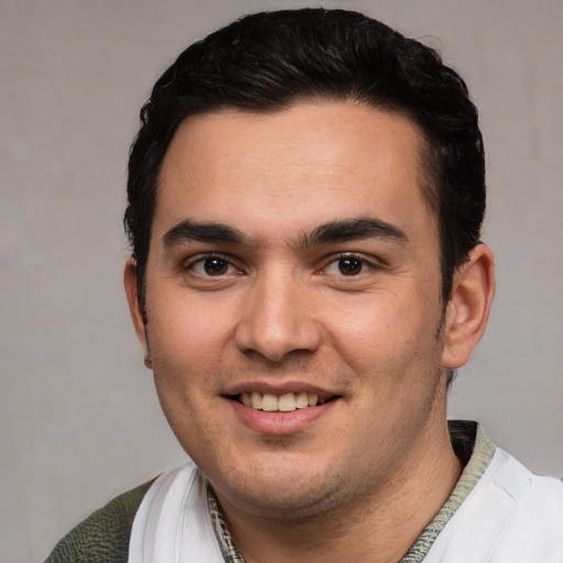 Joyful white young-adult male with short  black hair and brown eyes