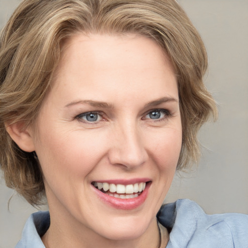 Joyful white young-adult female with medium  brown hair and blue eyes