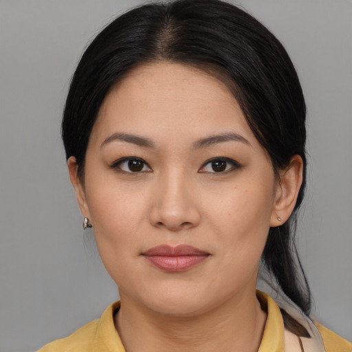 Joyful asian young-adult female with medium  brown hair and brown eyes