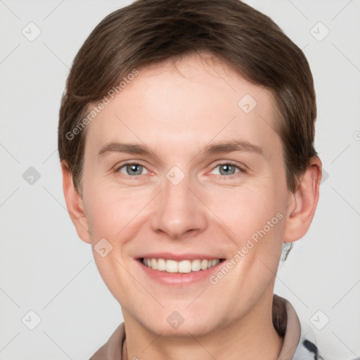 Joyful white young-adult male with short  brown hair and grey eyes