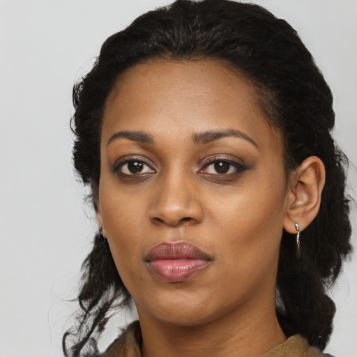 Joyful black young-adult female with long  black hair and brown eyes