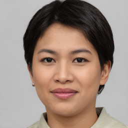 Joyful asian young-adult female with short  black hair and brown eyes