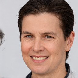 Joyful white adult male with medium  brown hair and brown eyes