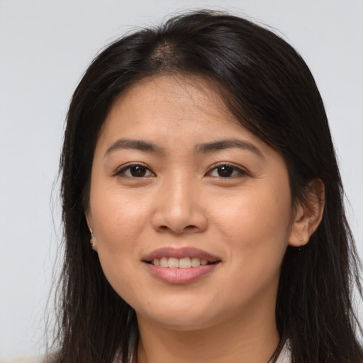 Joyful asian young-adult female with long  brown hair and brown eyes