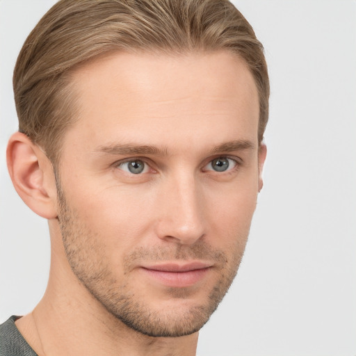 Joyful white young-adult male with short  brown hair and grey eyes