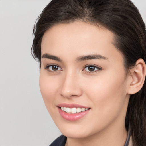 Joyful white young-adult female with long  brown hair and brown eyes