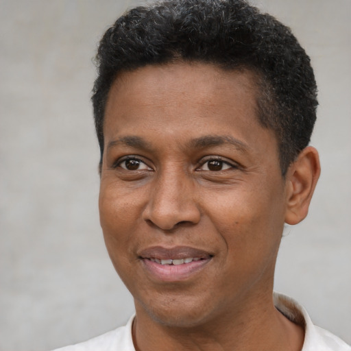 Joyful latino adult male with short  black hair and brown eyes