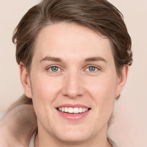 Joyful white young-adult female with medium  brown hair and green eyes