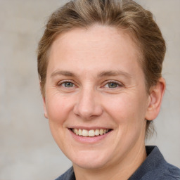 Joyful white adult female with medium  brown hair and grey eyes