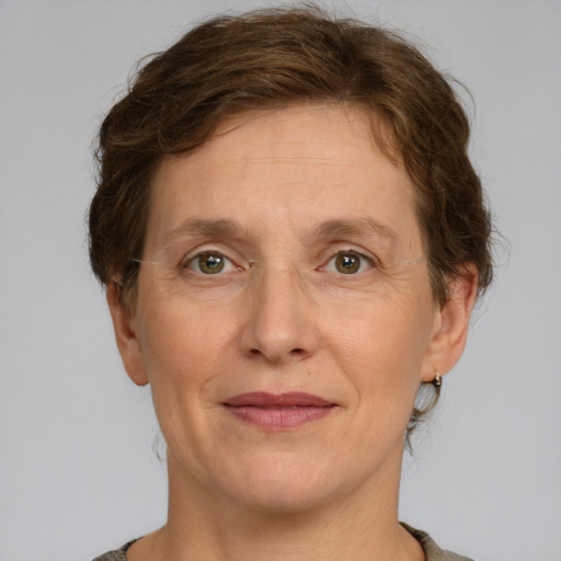 Joyful white adult female with short  brown hair and green eyes