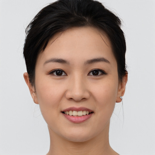 Joyful asian young-adult female with short  brown hair and brown eyes