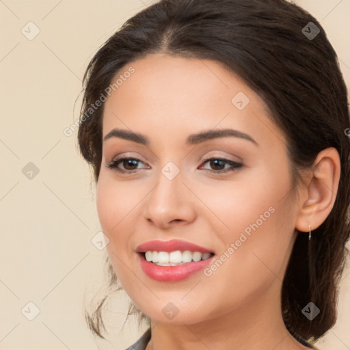 Joyful white young-adult female with long  brown hair and brown eyes