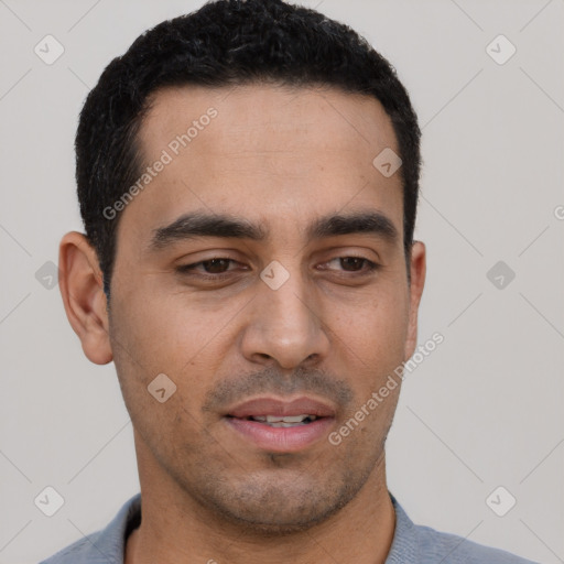 Joyful latino young-adult male with short  black hair and brown eyes